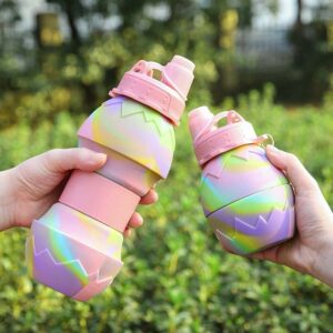 Pair of tie-dye pastel silicone/plastic water bottles held outdoors